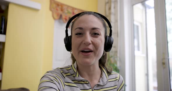 Happy smiling woman at home having a video call with family and friends