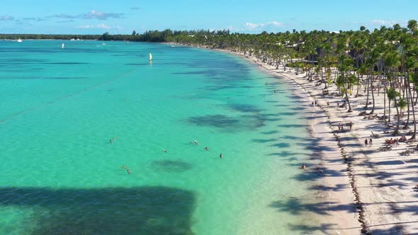 Tropical Coastline with Resorts Palm Trees and Caribbean Sea with Floating Boats and People Having