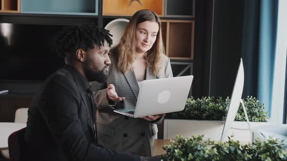 African American Business Man and His Assistant Light Girl Discussing Tasks for the Day at Office