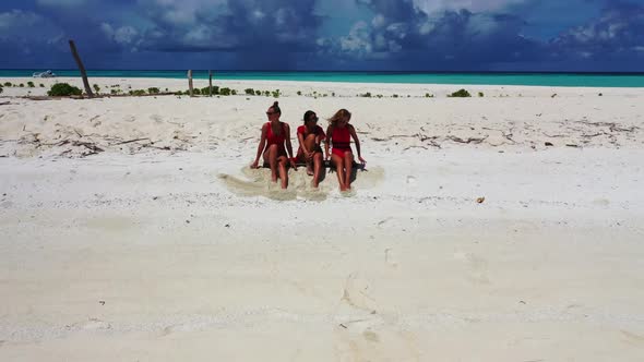 Beautiful women posing on relaxing shore beach voyage by shallow lagoon and white sandy background o