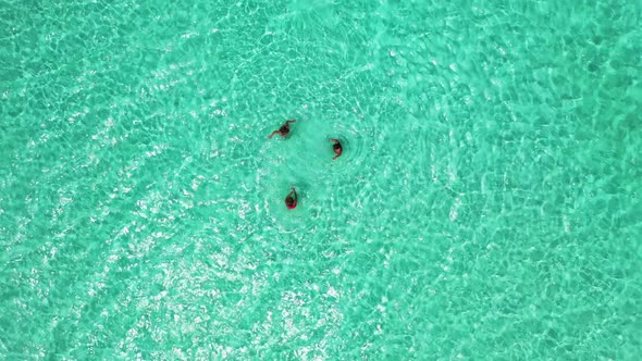 Girls sunbathing on marine coast beach vacation by blue ocean and white sand background of the Maldi