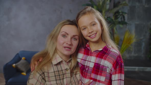 Portrait of Smiling Pretty Mom and Daughter Embracing