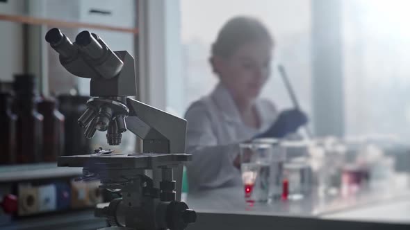 Scientist Work with Science Equipment in Laboratory