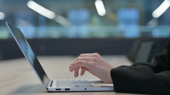 Close Up of Female Hands Typing on Laptop Keyboard