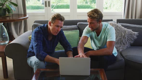 Caucasian man with his father discussing together at home