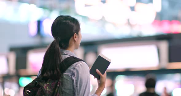 Young Travel woman holding passport in the airport 