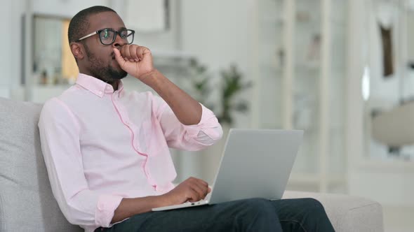 Sick African Man with Laptop Coughing at Home 