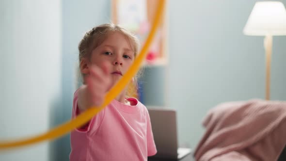 Pretty Little Girl Turns Gymnastic Ring on Arm at Home