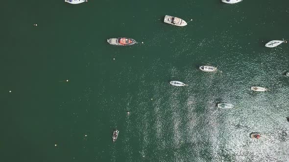 Overhead view zooming in to docked boats in Brixham England. English harbour in the southwest.