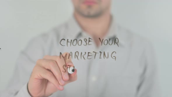 Choose Your Marketing Strategy Writing on Screen with Hand