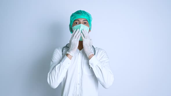 Surprised young male nurse on a white background