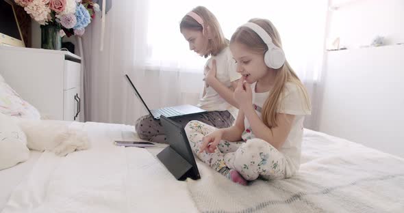 Kids Girls Using Digital Tablet and Headphone