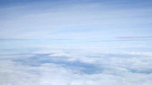 View of sky and clouds from passenger plane