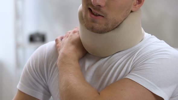 Man Wearing Foam Cervical Collar Suffering From Pain in Shoulder and Neck