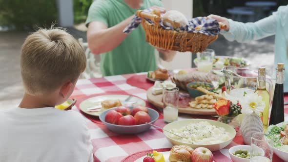 Happy family eating together at table