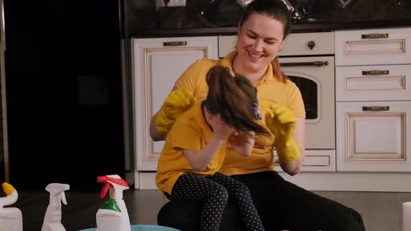 Mother and Daughter Have Fun at Home in Kitchen, They Clean Together and Laugh.