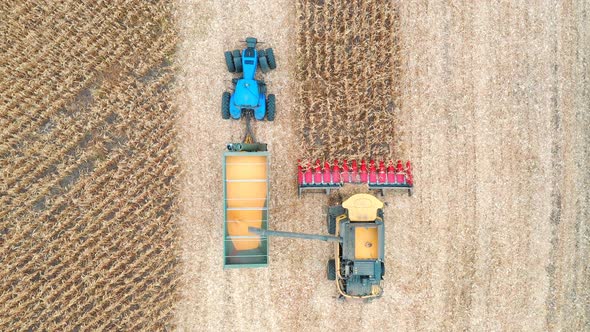 Aerial View of Combine Loading Off Corn Grains Into Tractor Trailer