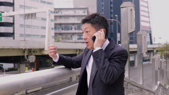 Japanese businessman talking on a cell phone