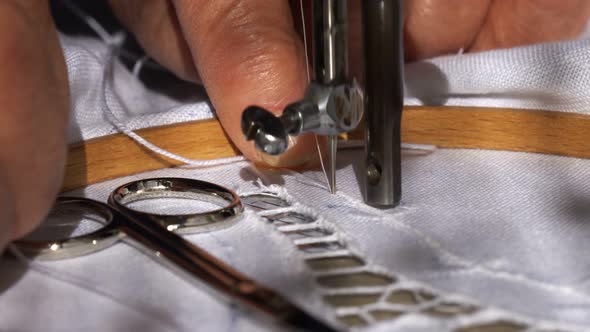 An Old Woman is Working with a Sewing Machine