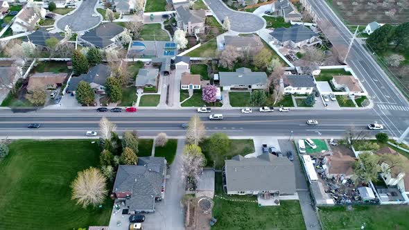 Flying parallel with traffic driving in neighborhood