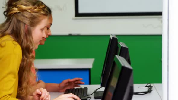 Students studying on computer in classroom