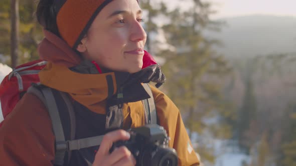 Female Photographer Taking Pictures of Nature during Winter Hike