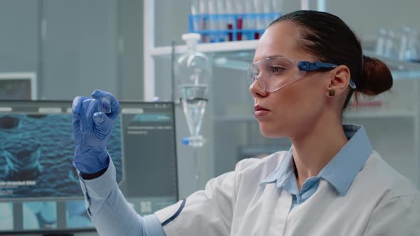 Chemistry Specialist Analyzing Blood Sample on Glass