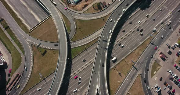 Aerial drone view of highway multi-level junction road with moving cars