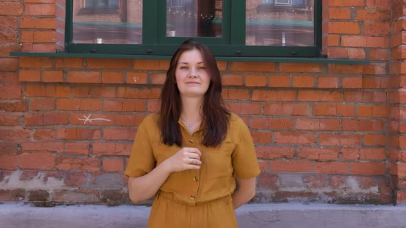 Women with a Smile Raises Her Hand Shows a Thumb Approving Finger Up