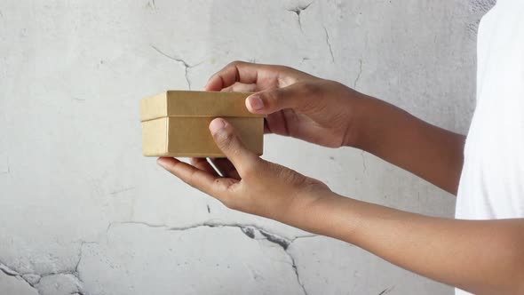 Side View of Person Open a Empty Small Gift Box