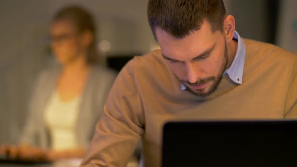 Office Workers with Laptop Working at Night 