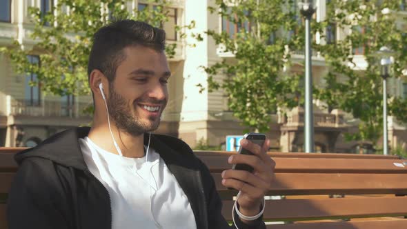 A Cheerful Guy Answers a Video Call on the Phone