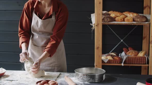 Woman Making Dough in Bakery Kitchen