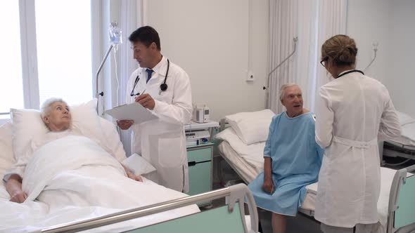 Healthcare Workers Visiting Patients in Hospital Ward