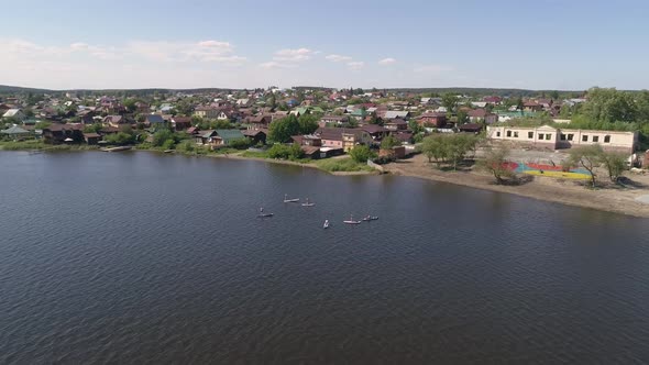 Aerial view of Stand Up Paddling on pond in provincial city 01