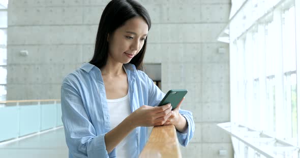 Woman Working on Mobile Phone in University