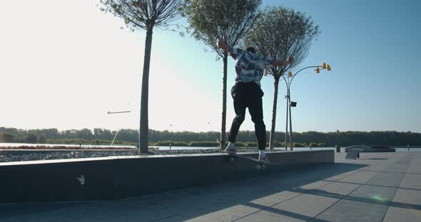 Young Man Is Rail Sliding at the Skatepark, Doing Skater Tricks, 