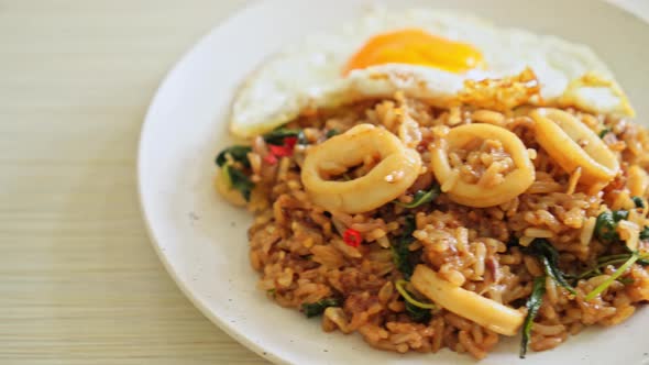 fried rice with squid and basil topped fried egg in Thai style - Asian food style