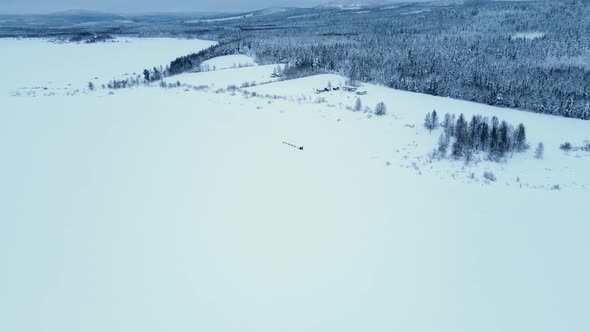 Aerial view of dogs pulling a sled in Overtornea, Sweden.