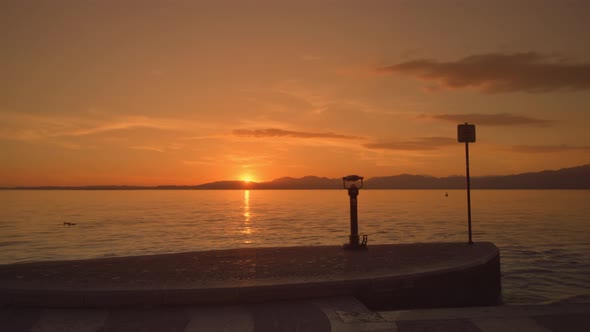 Empty City Embankment and Beautiful Sunset at Lake Garda