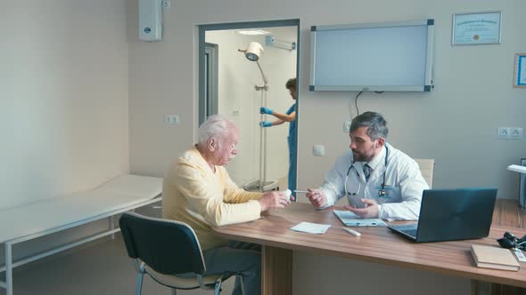 Old man asking doctor about medicine in cabinet