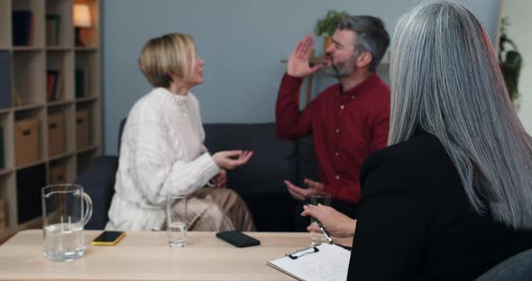 Female Psychologist Trying to Calm Down Married Couple That Discussing Family Problems and Shouting