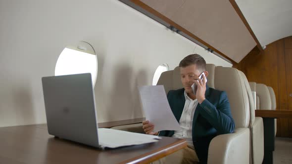 Mature Business Man Talking By Mobile Phone Partner Connection Aircraft Jet Travel