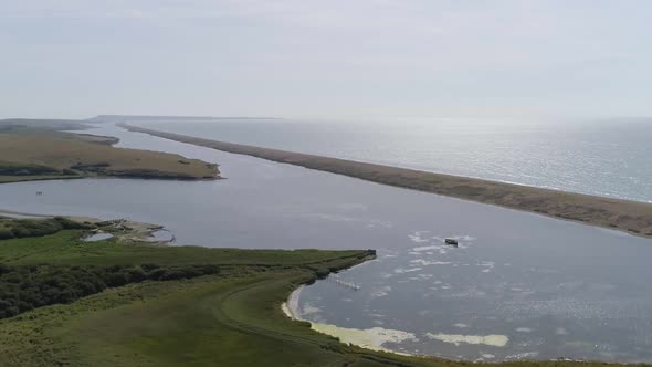 Aerial tracking from left to right with a slight rotation looking over the fleet lagoon at Abbotsbur