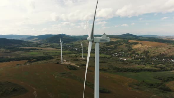 Camera Flight Over Landscape with Power Plant. Aerial View To Wind Turbine. Sustainable Electricity