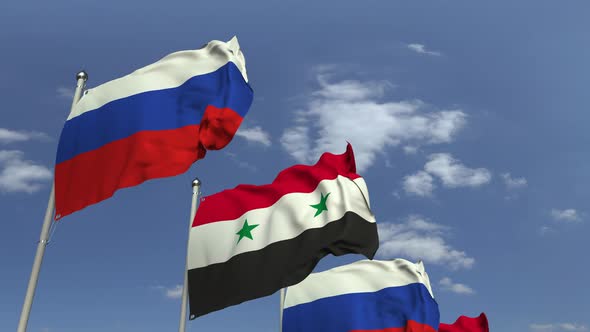 Flags of Syria and Russia Against Blue Sky alt