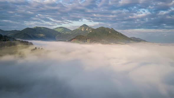 Magic Fly Above Clouds in Green Mountains