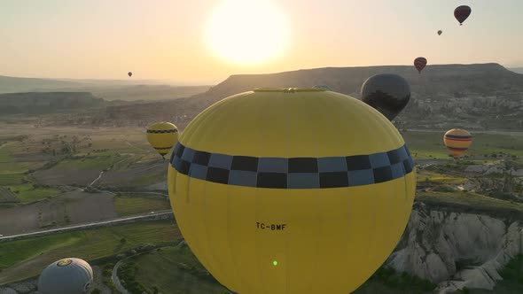 4K Aerial view of Goreme. Colorful hot air balloons fly over the valleys.