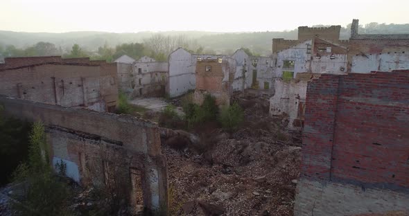 The camera flies over the ruins of the factory