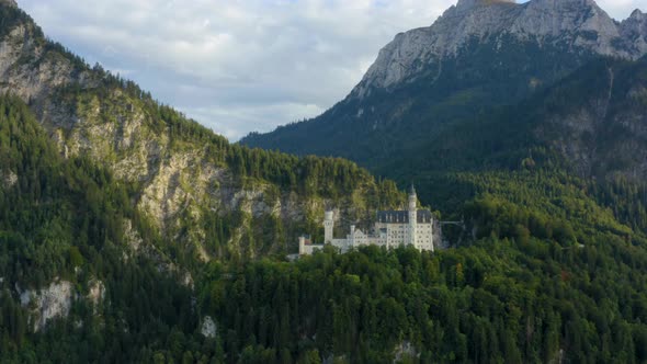 Neuschwanstein Castle, Bavarian Alps Germany, aerial zoom out panorama